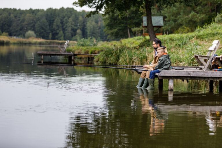 Father and son fishing on a lake.