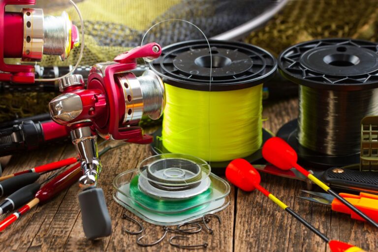 Fishing reels and and hooks on the wood.