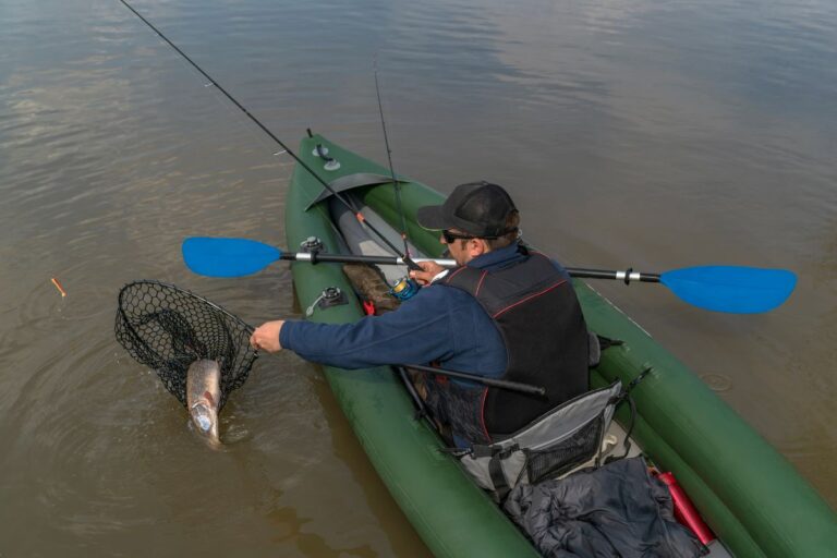 A man on kayak fishing with a big catch.