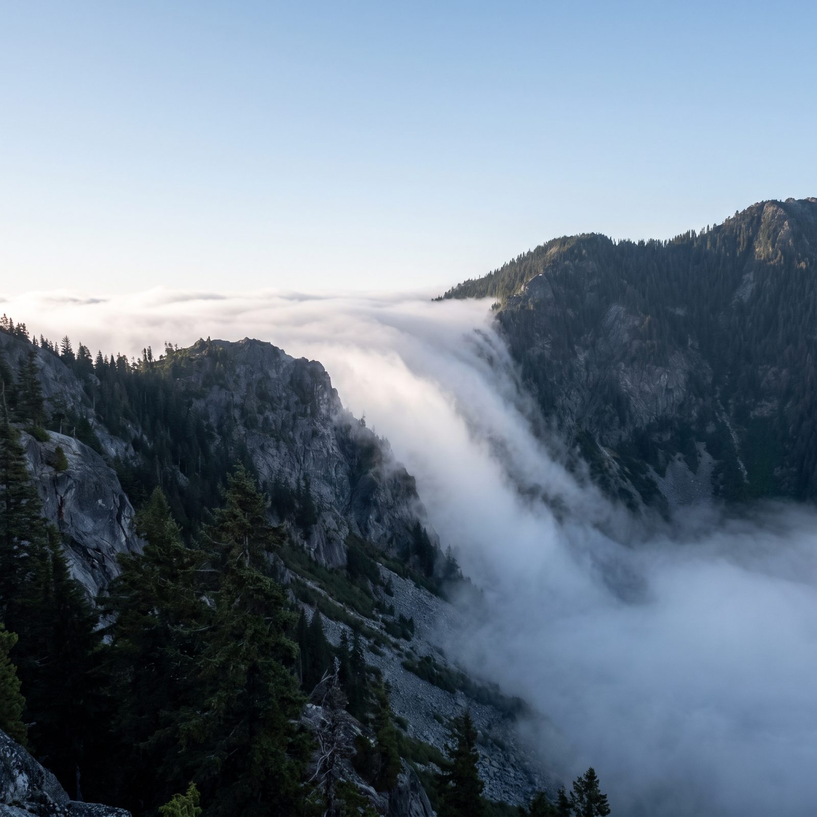 Fog Pouring Over a Saddle Shows Air Spilling Across the Divide